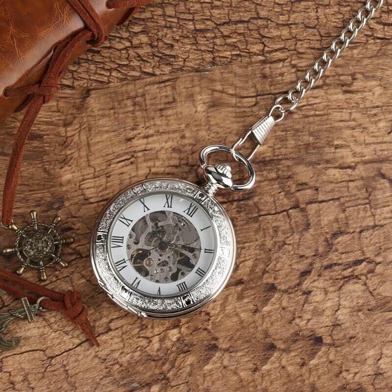 Vintage Silver and Gold Mechanical Pocket Watches with skeleton dial on rustic background