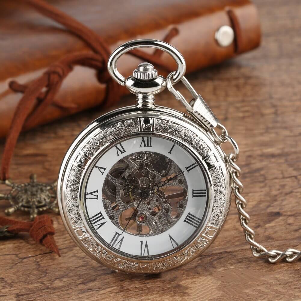 Vintage Silver and Gold Mechanical Pocket Watches with skeleton dial on rustic wooden surface.