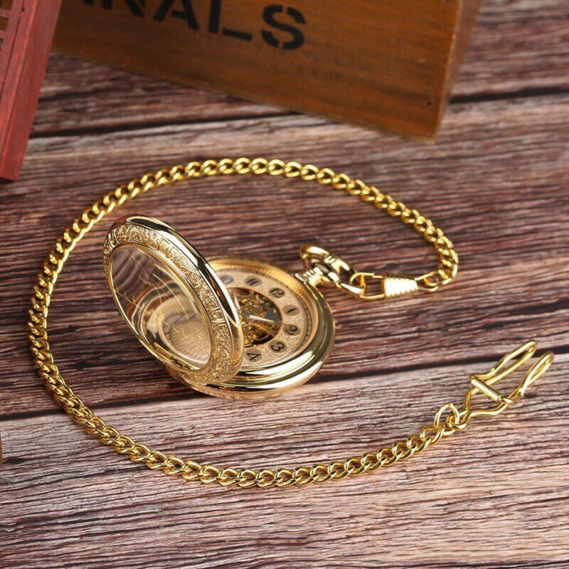 Vintage Silver and Gold Mechanical Pocket Watches with exposed mechanics and elegant chain on wooden surface.
