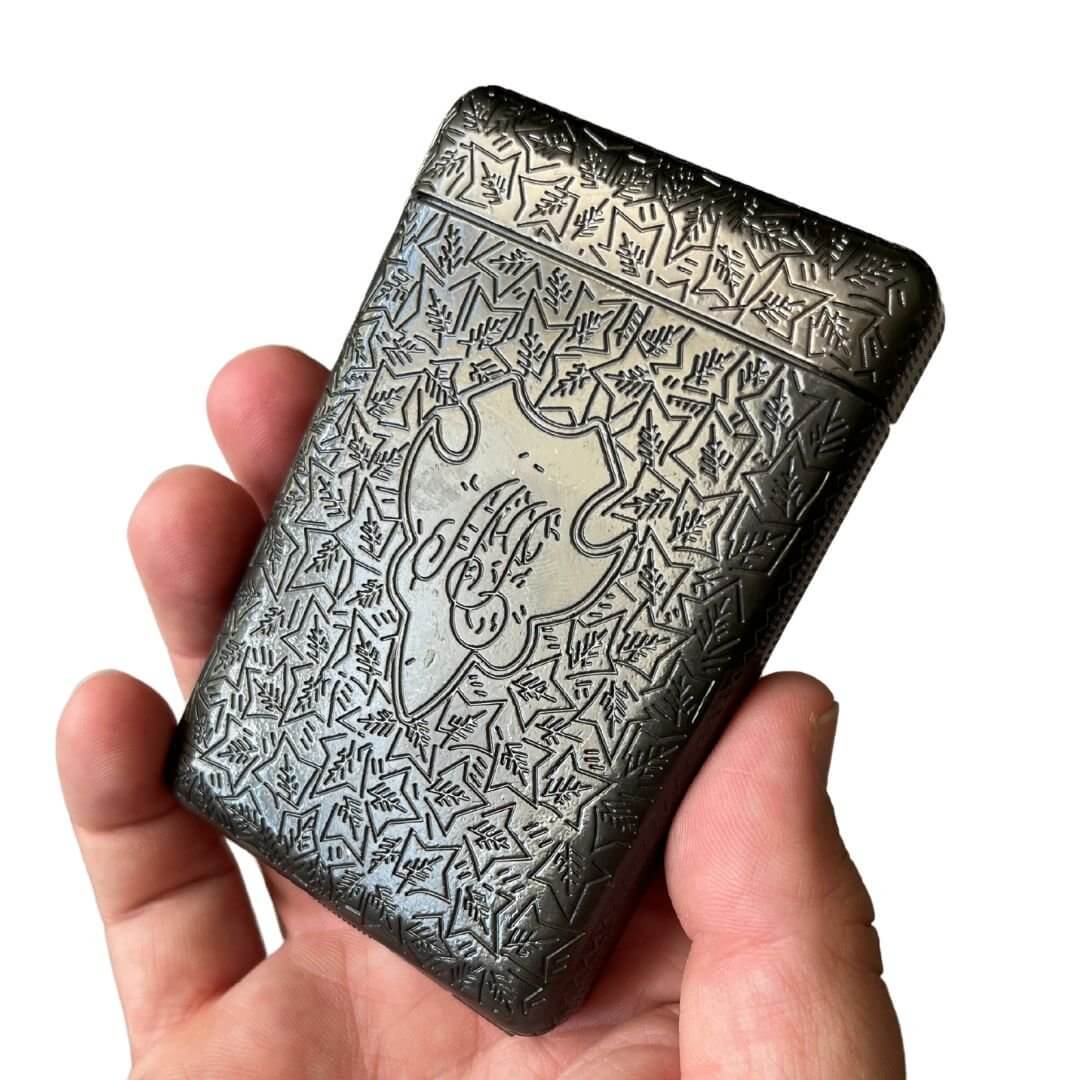 Vintage 1920s Cigarette Case in hand showcasing etched metal design and craftsmanship.