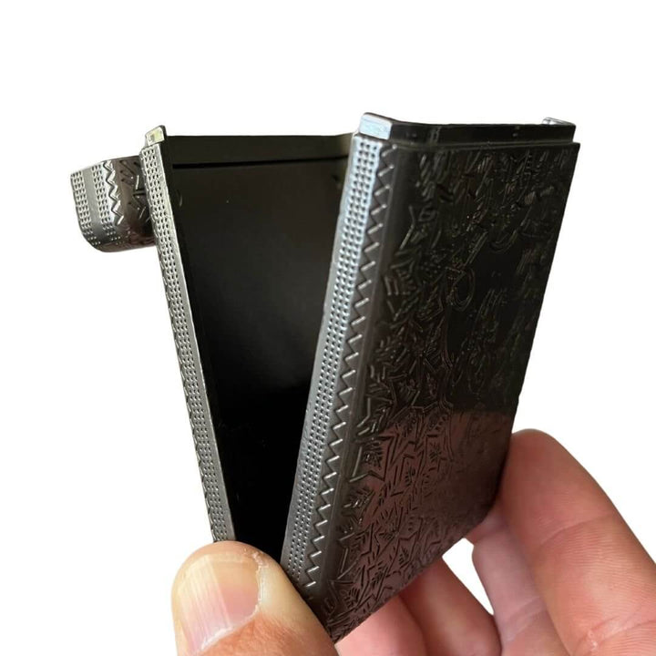 Vintage 1920s Cigarette Case with etched metal design and open spring-loaded hinge showcasing craftsmanship of the Roaring Twenties.