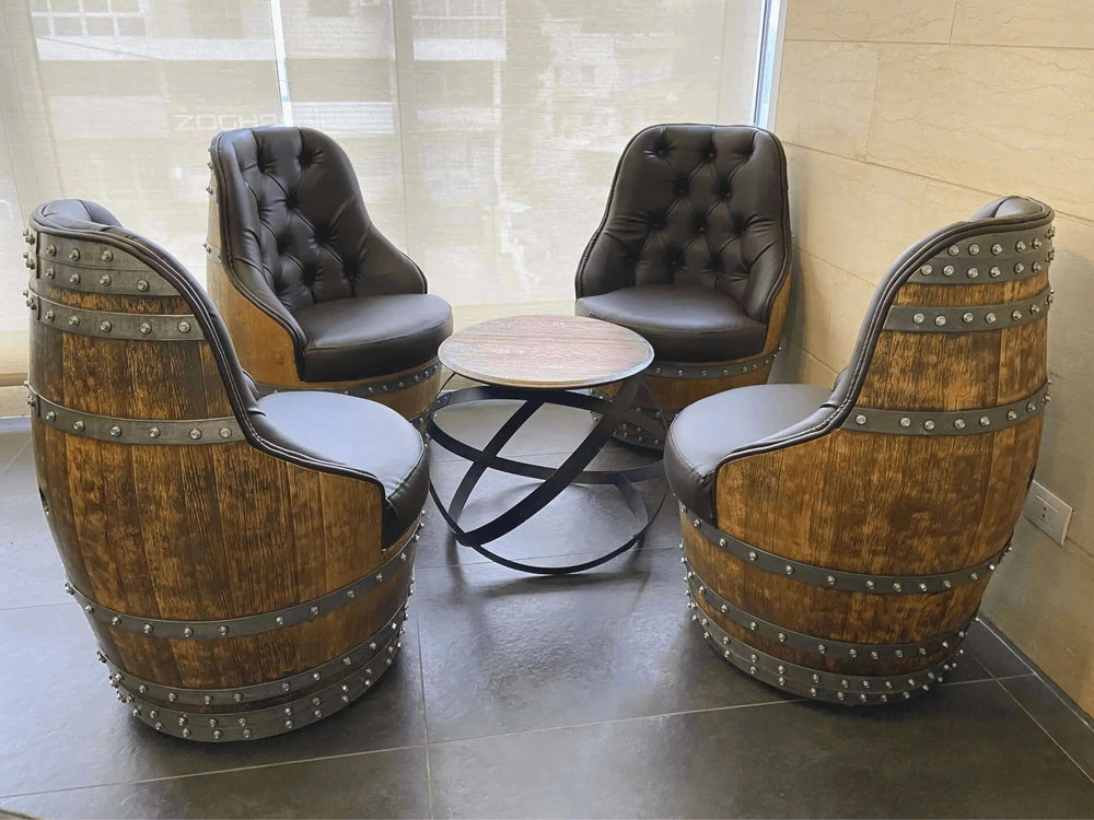 Set of four Tufted Vintage Barrel Chairs with handcrafted upholstery and reclaimed wood, surrounding a rustic round table.