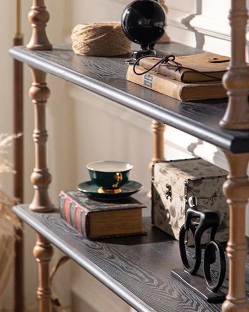 Close view of the dark wood shelves styled with books and decorative objects