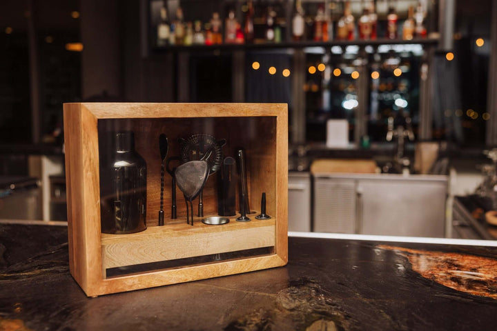 Vintage-Style Bartender Kit with Mango Wood Case & Bar Tools displayed on a bar counter in an elegant setting