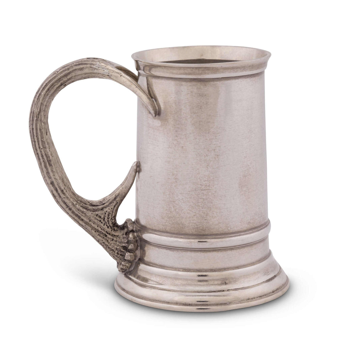 Pewter tankard with decorative handle on a white background
