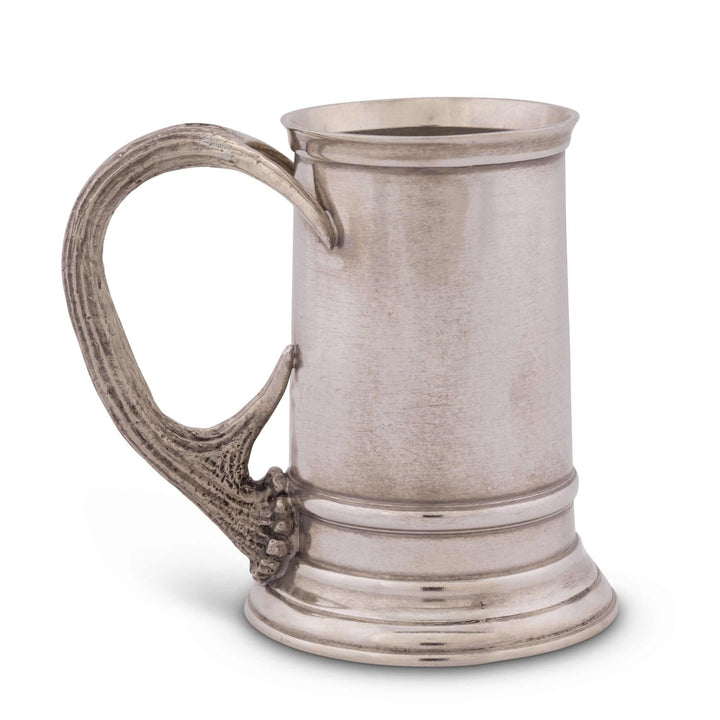 Pewter tankard with decorative handle on a white background