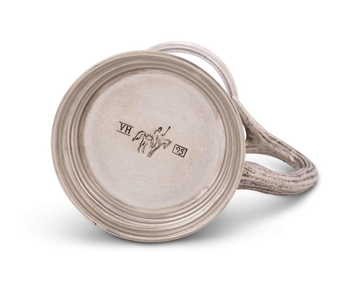 Pewter mug with decorative handle on a white background
