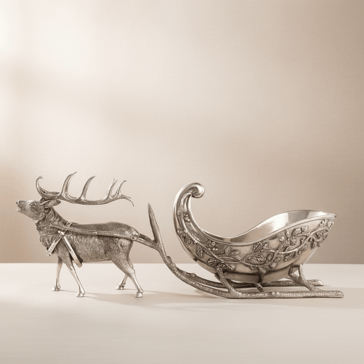 Decorative silver reindeer and sleigh on a beige background