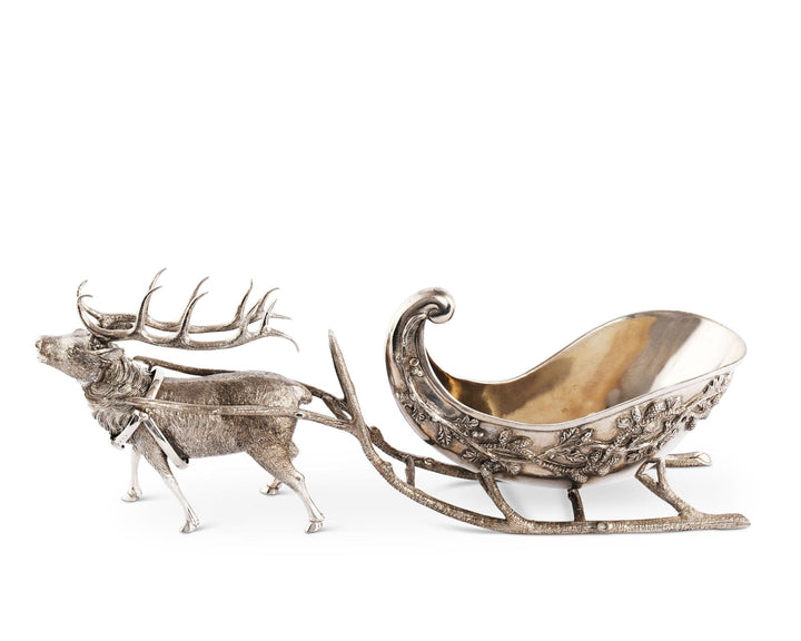 Decorative silver reindeer pulling a sleigh on a white background