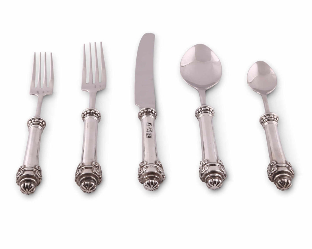 Set of silver flatware including forks and spoons on a white background