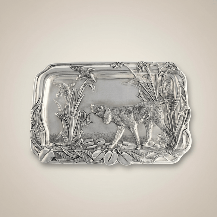 Decorative silver tray with a dog design on a beige background