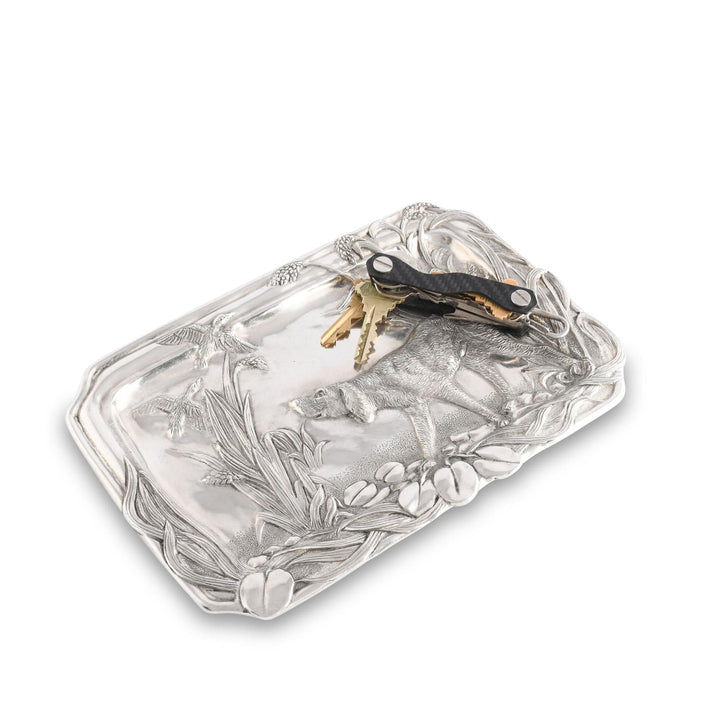 Decorative silver tray with floral patterns on a white background