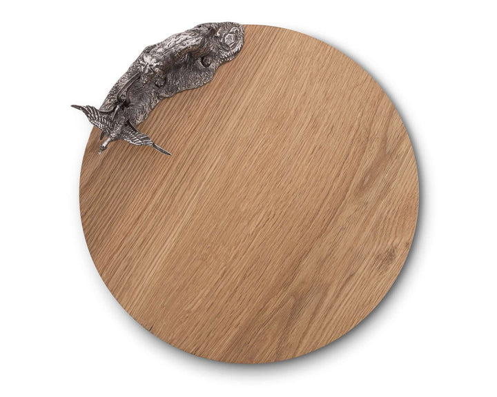 Round wooden cheese board with a large moth on a white background