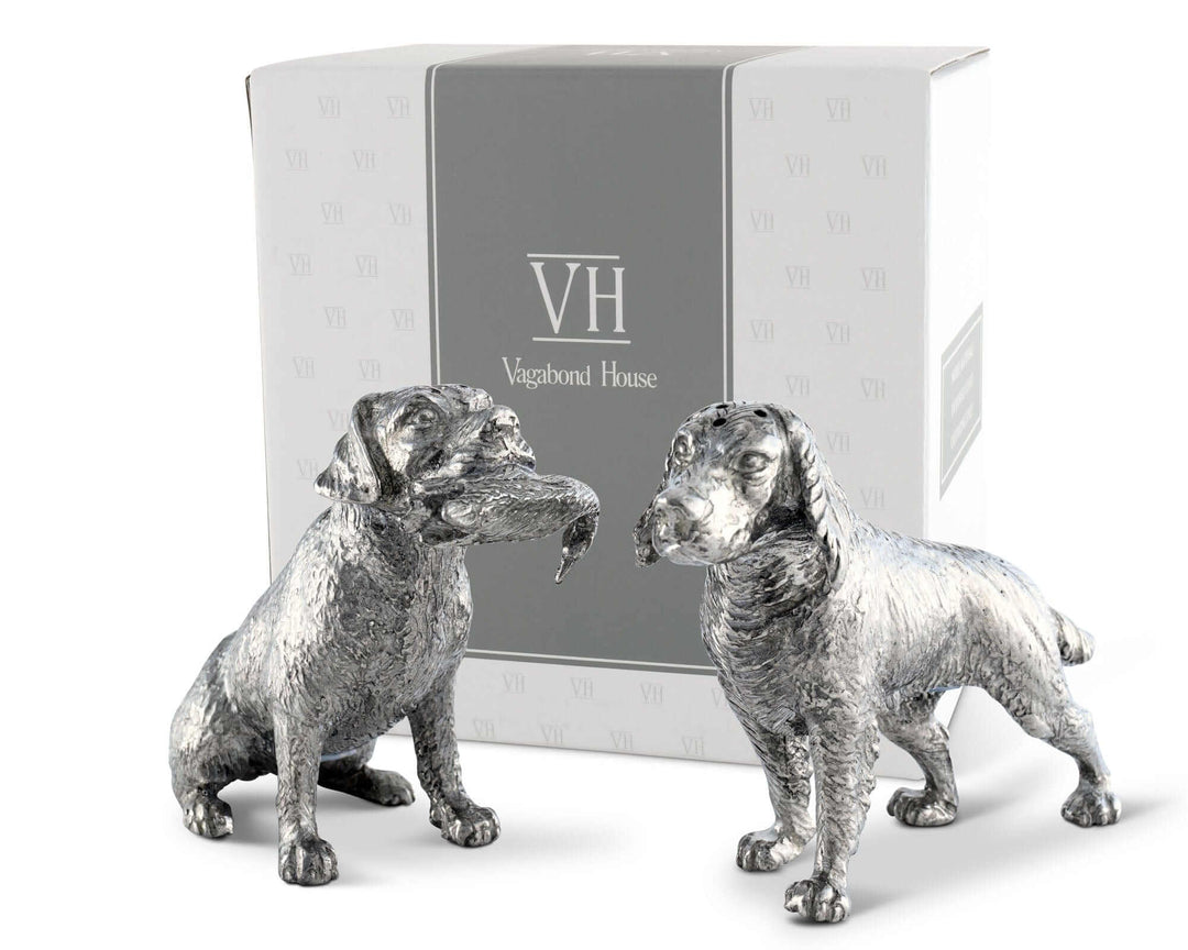 Two silver dog salt and pepper shaker figurines in front of a Vagabond House branded box.
