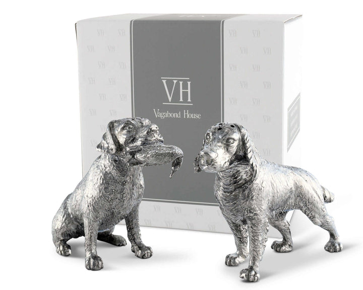Two silver dog salt and pepper shaker figurines in front of a Vagabond House branded box.