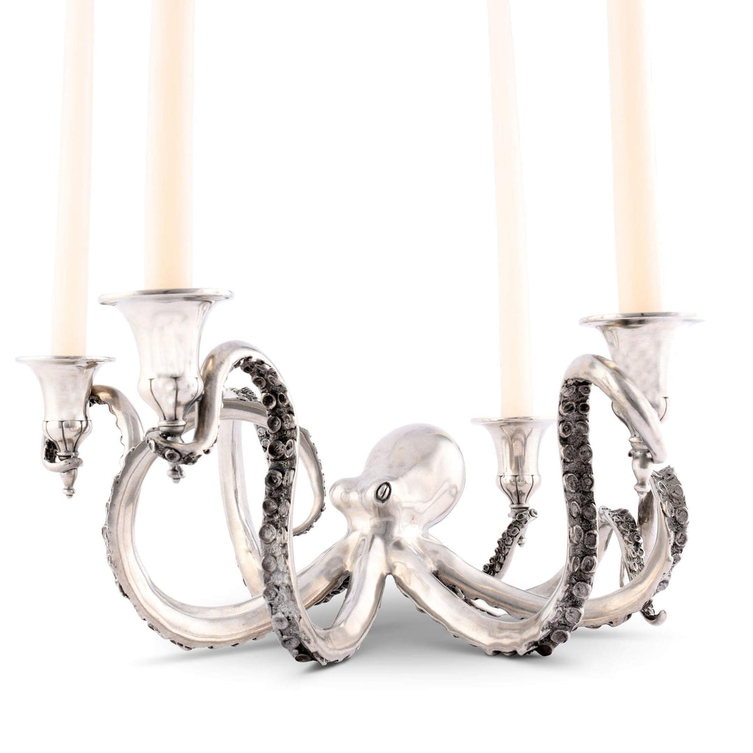 Silver octopus-shaped candle holder with four candle holders on a white background