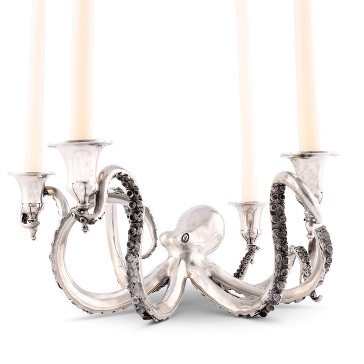 Silver octopus-shaped candle holder with four candle holders on a white background
