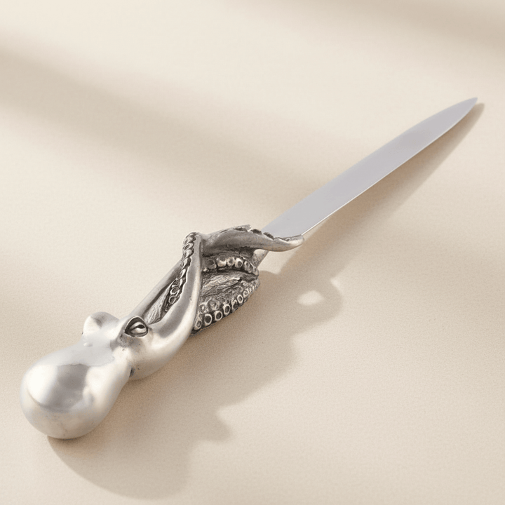 Decorative letter opener with an octopus design on a beige background