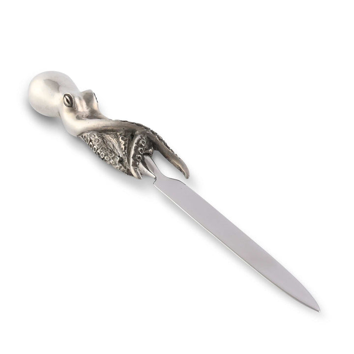 Silver letter opener shaped like a squid on a white background