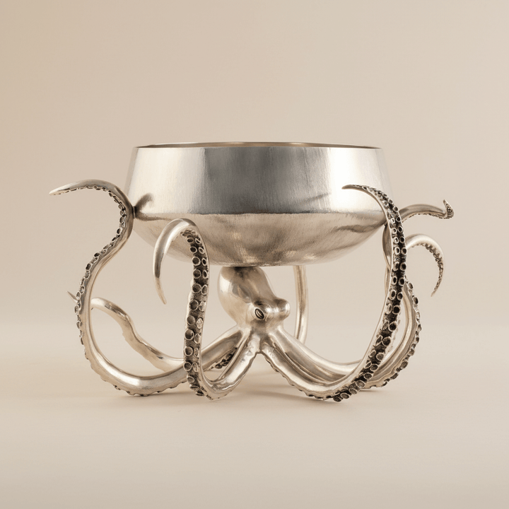 Silver octopus-shaped bowl on a beige background