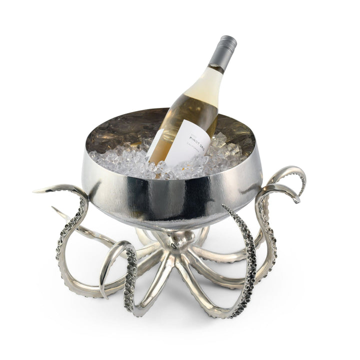 Metallic octopus-shaped wine cooler with a bottle of white wine on a white background