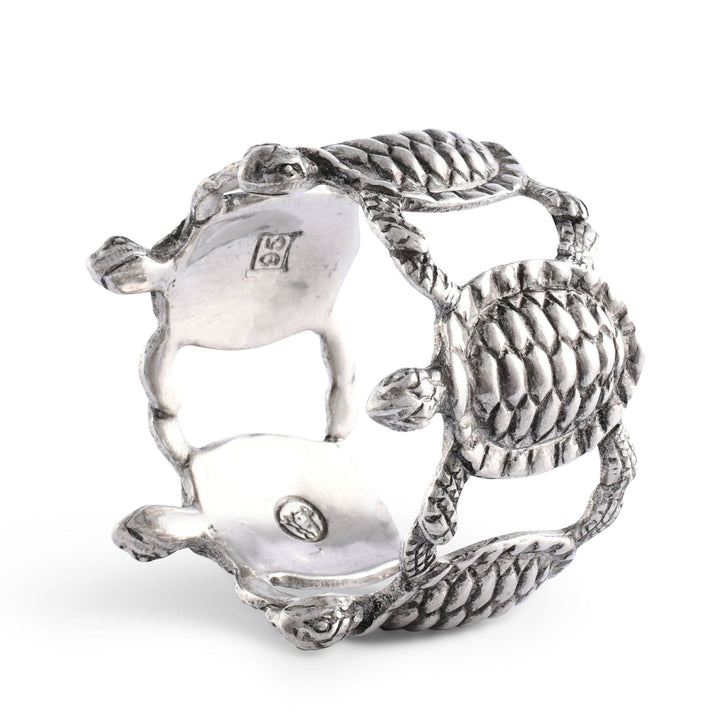 Silver turtle-shaped napkin ring on a white background