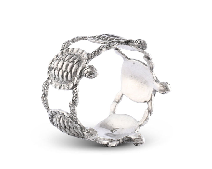 Silver napkin ring with turtle design on a white background