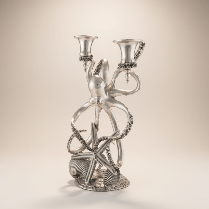 Silver octopus-shaped candelabrum on a beige background