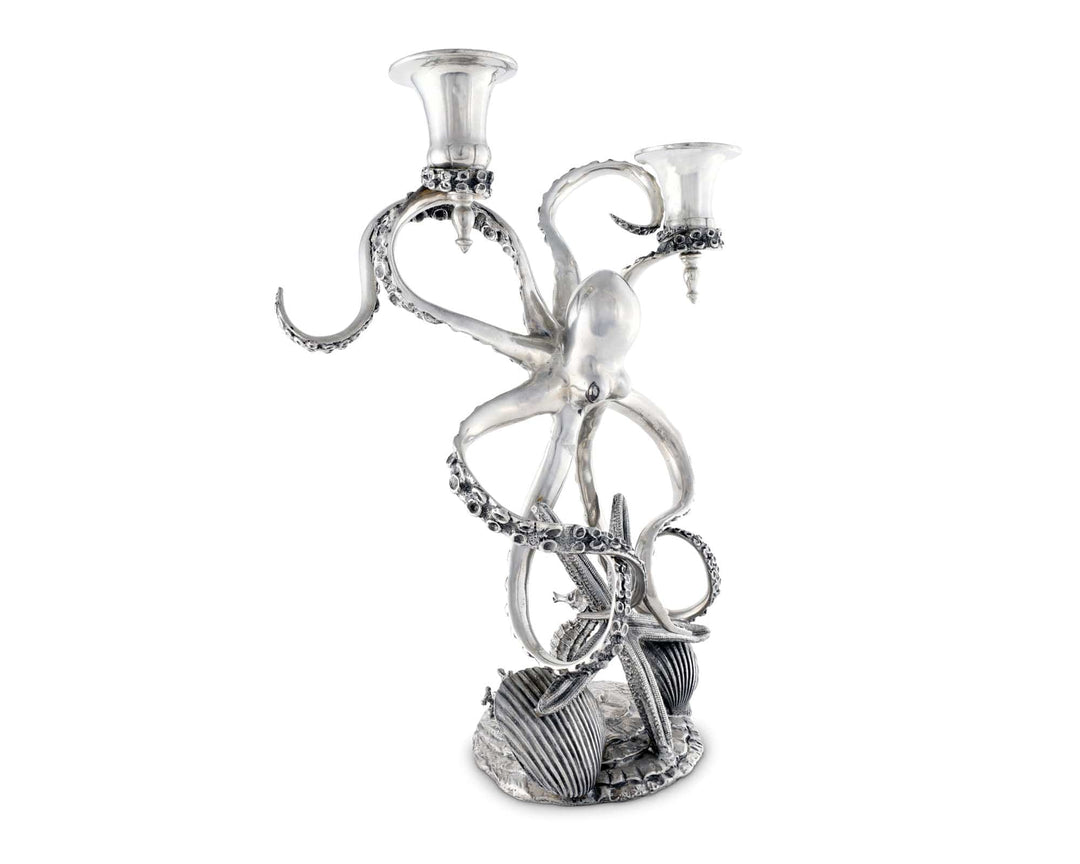 Silver octopus candle holder with two candles on a white background