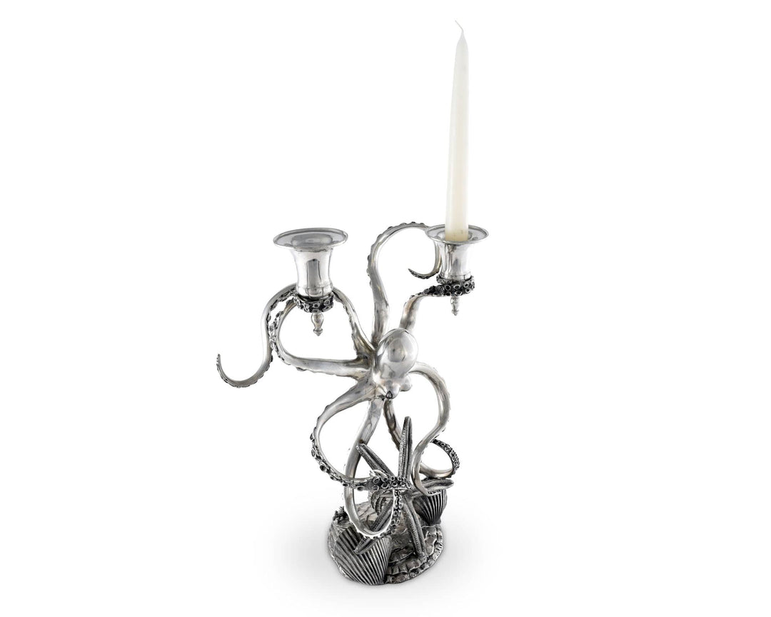 Silver octopus candle holder with a candle on a white background