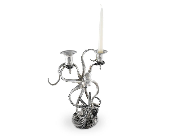 Silver octopus candle holder with a candle on a white background