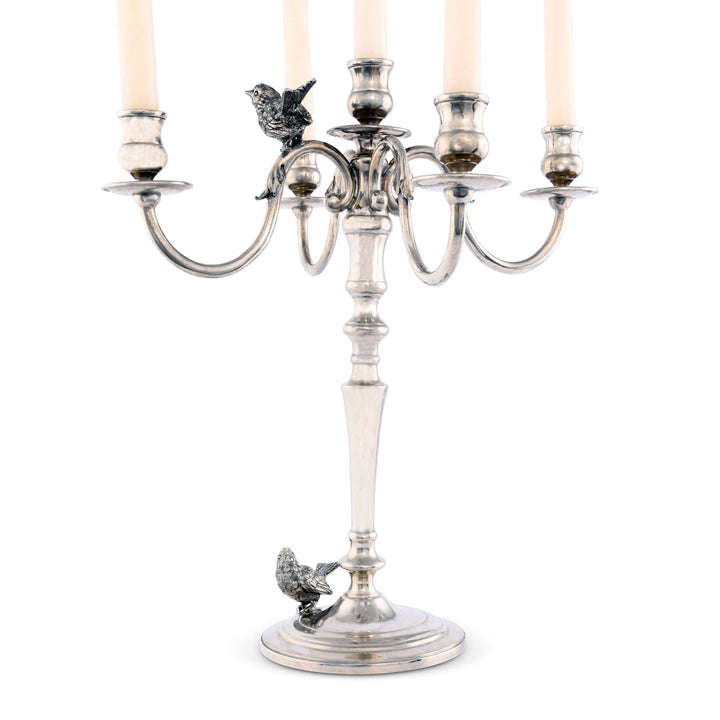 Silver candelabra with candle holders and decorative birds on a white background