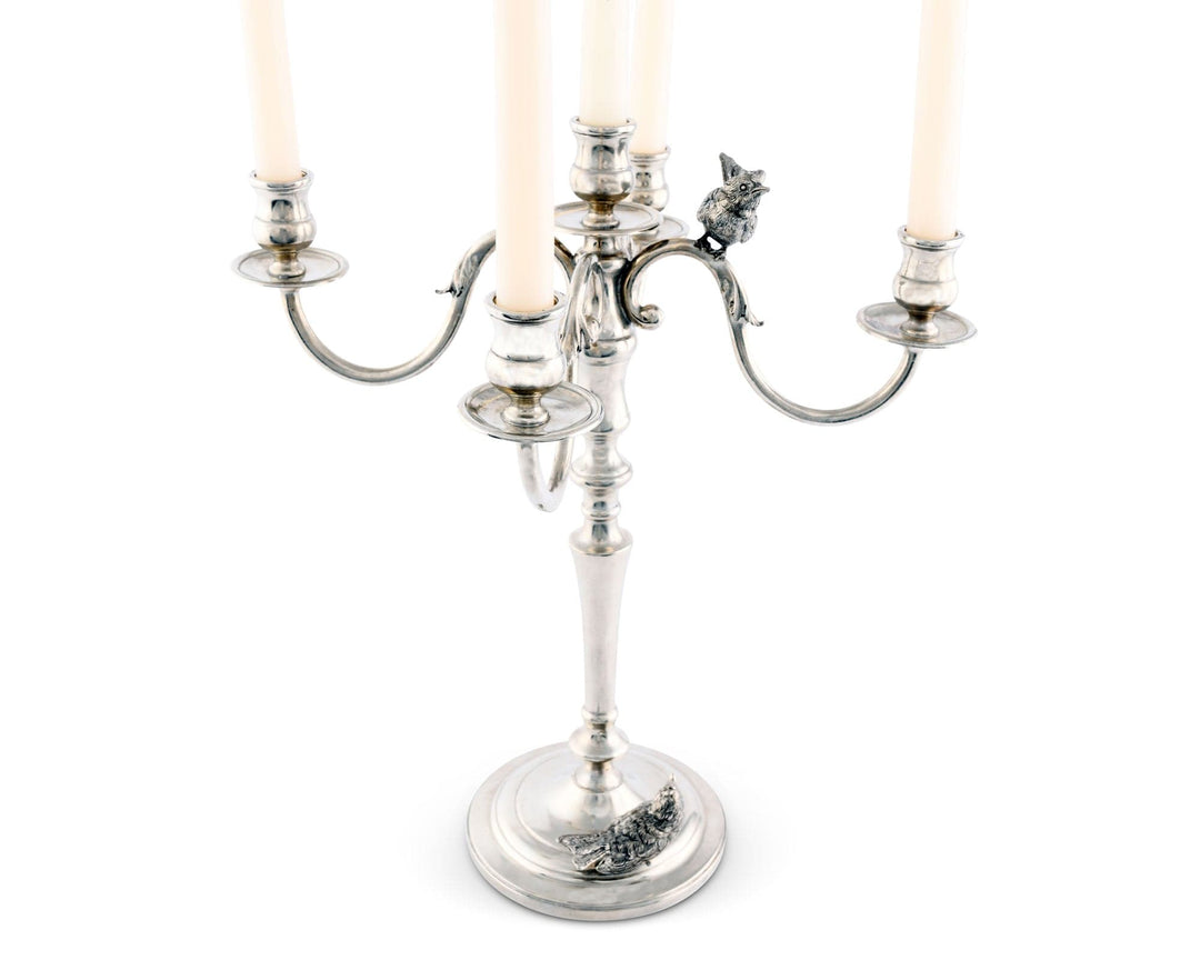 Silver candelabra with candles on a white background