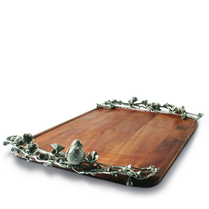 Wooden tray with decorative metal edge and bird design on a white background