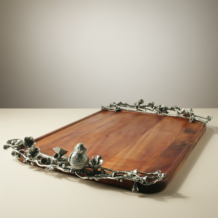 Wooden tray with pewter metalwork border featuring birds and foliage on a neutral background