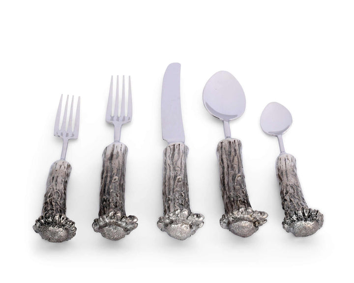 Set of silver cutlery with decorative handles on a white background