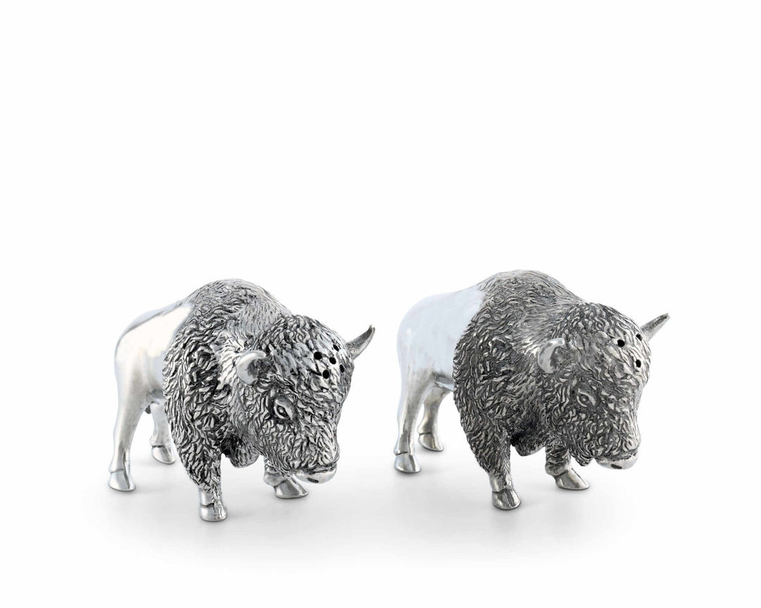 Two silver bison figurines on a white background