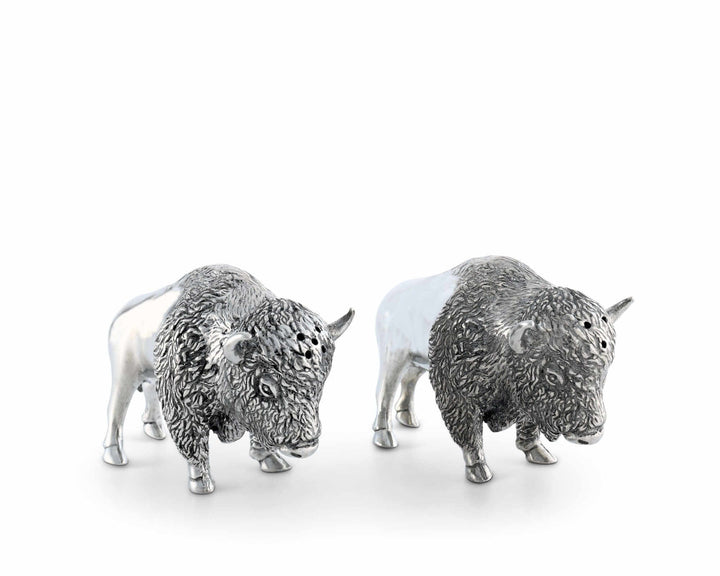 Two silver bison figurines on a white background