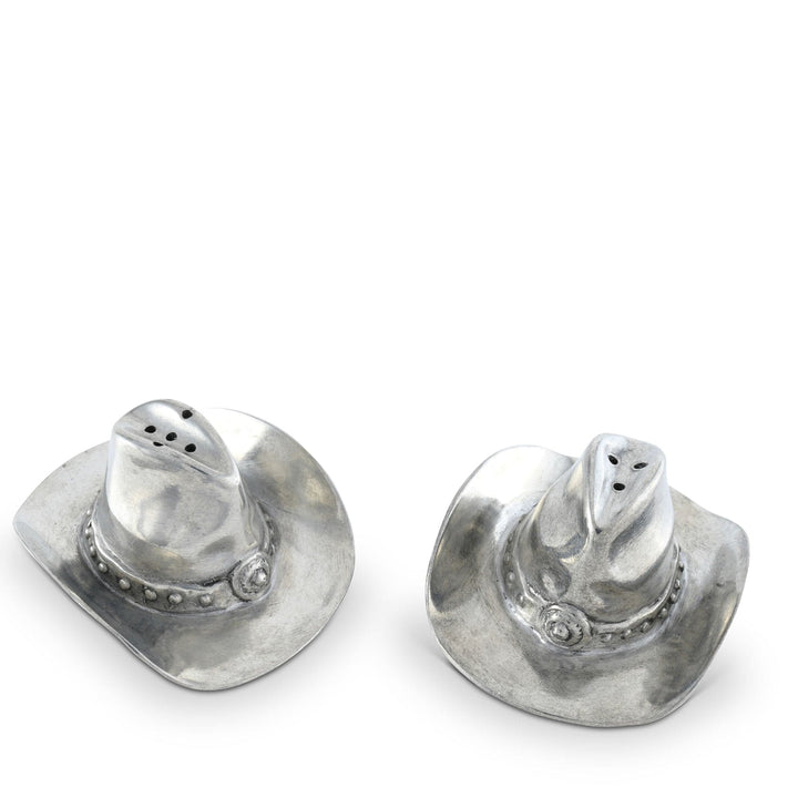 Pair of silver cowboy hat-shaped salt and pepper shakers on a white background