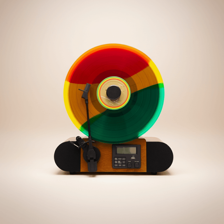 Colorful vinyl record on a small record player against a beige background