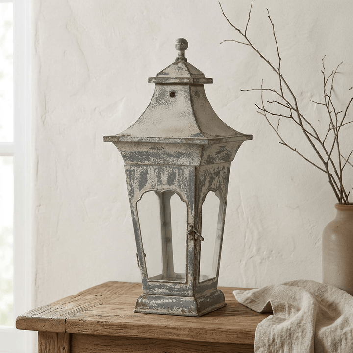 Small Vespera Iron Lantern displayed on a rustic wood console in a cottage interior