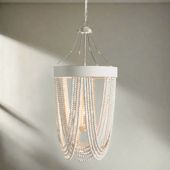 Vintage beaded chandelier with whitewashed wood beads, showcasing coastal elegance and bohemian charm.