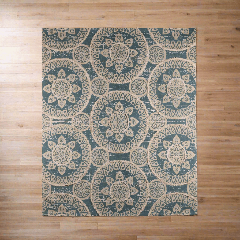 Vintage Boho Sun Pattern Handwoven Rug on wooden floor, featuring blue and ivory medallion design, creating a cozy, artistic ambiance.
