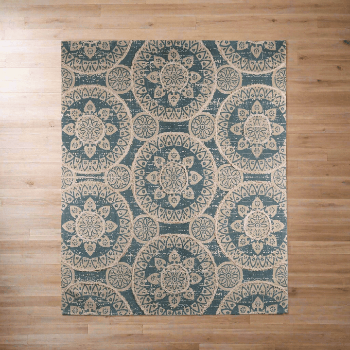 Vintage Boho Sun Pattern Handwoven Rug on wooden floor, featuring blue and ivory medallion design, creating a cozy, artistic ambiance.
