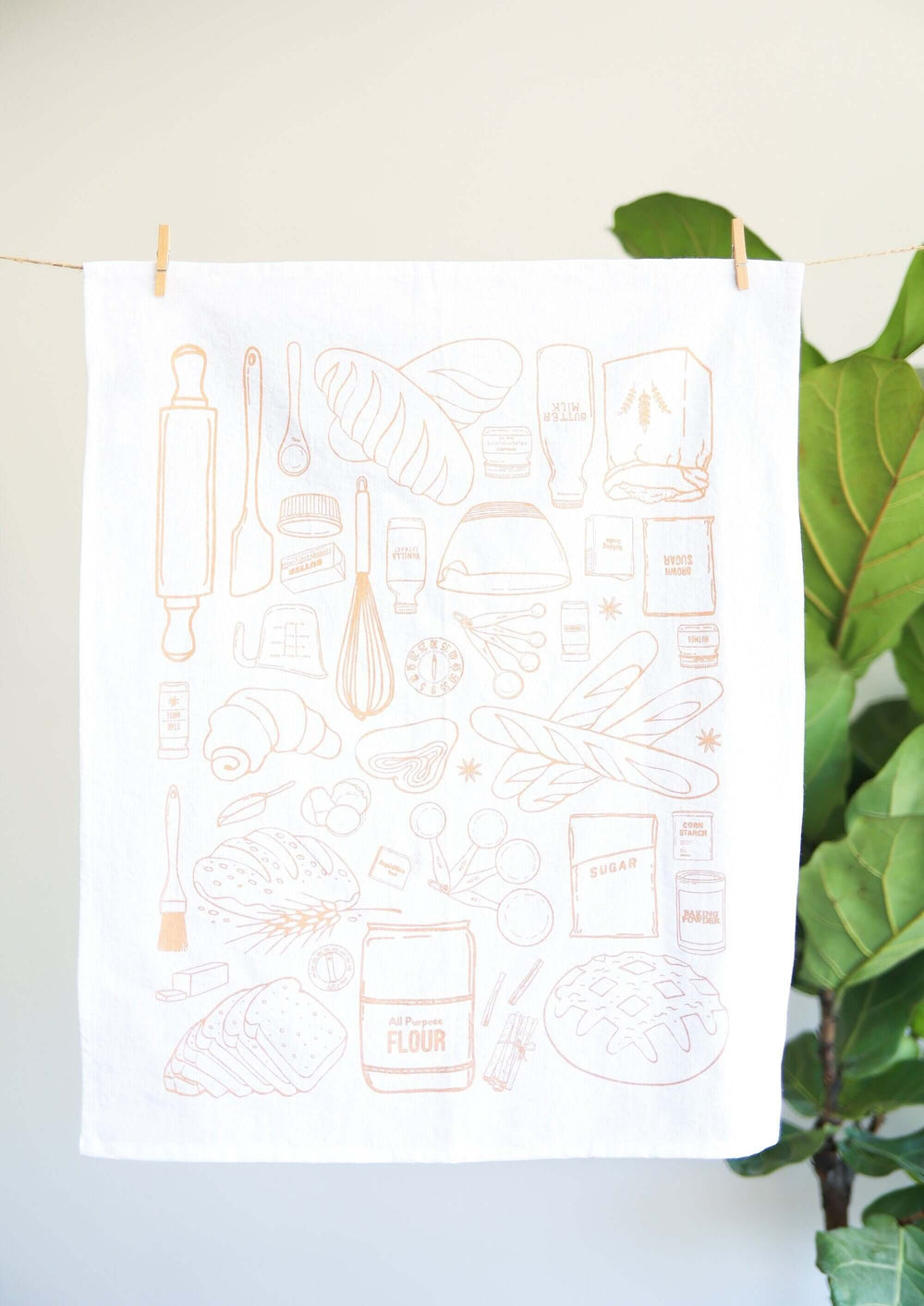 Vintage Bread Baking Tea Towel with hand-drawn illustrations hanging in a kitchen setting, capturing the essence of home baking.