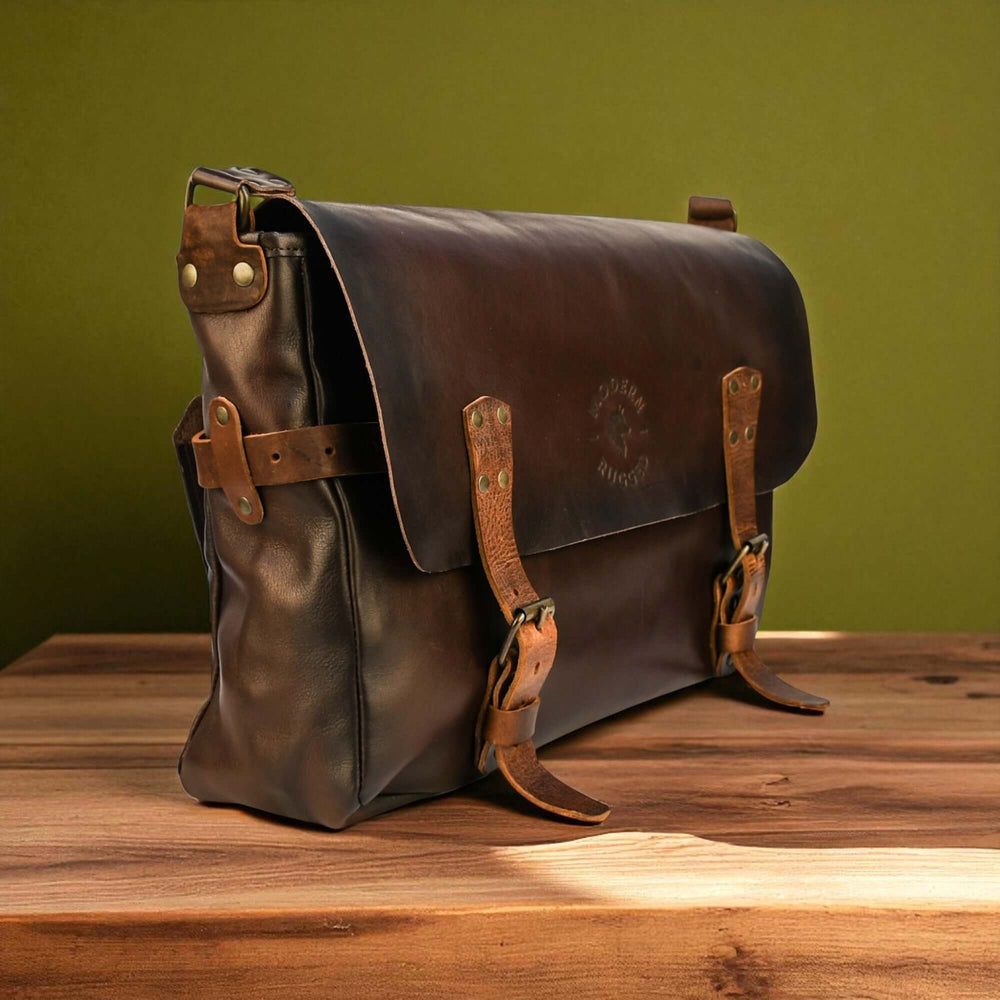 Vintage Brown Leather Messenger Bag on wooden table, classic design with buckled straps, ideal for urban and travel use.