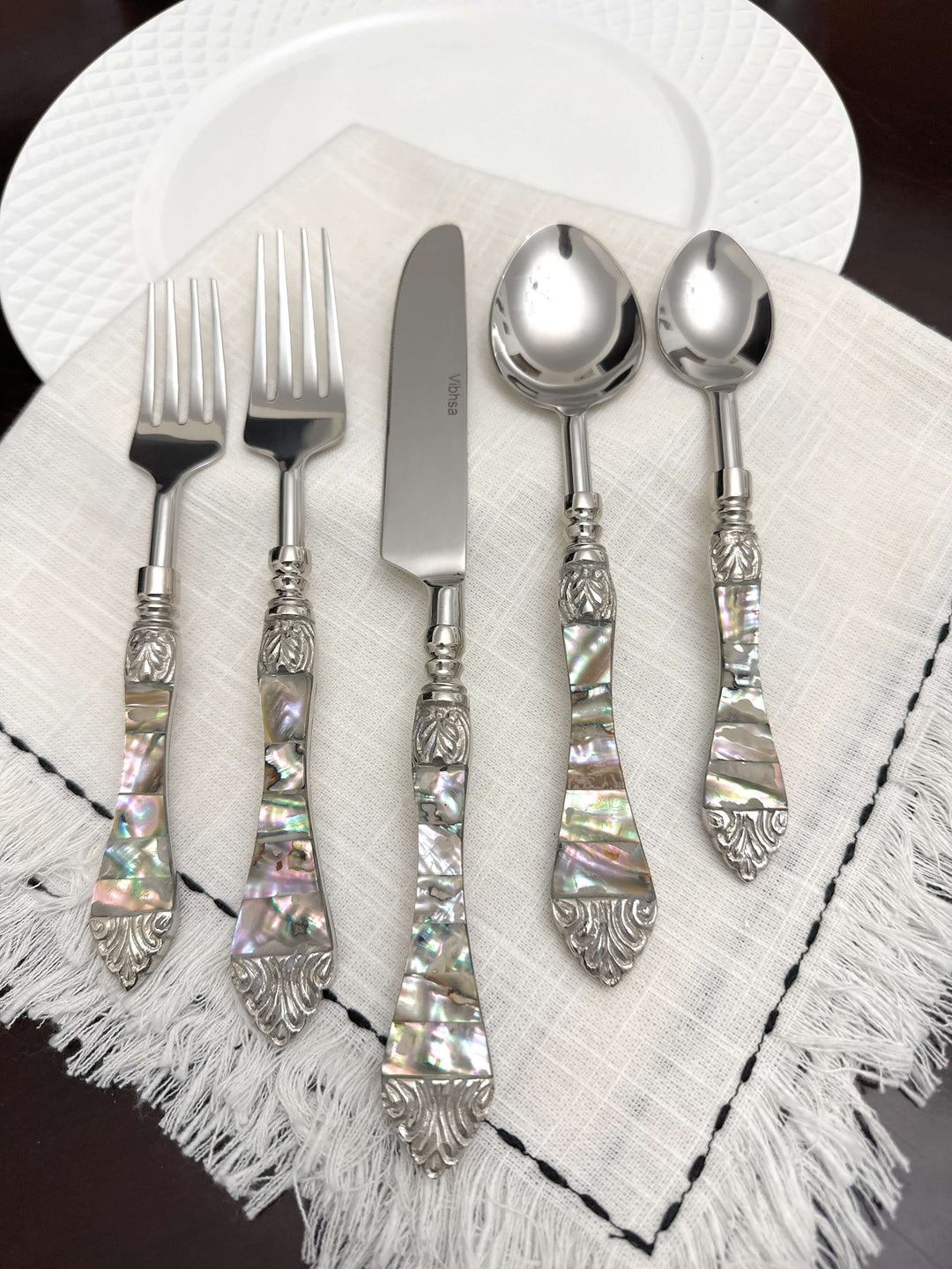 Vintage Coastal Flatware Set with Abalone Inlay Handles (Set of 20) displayed on table with iridescent design.