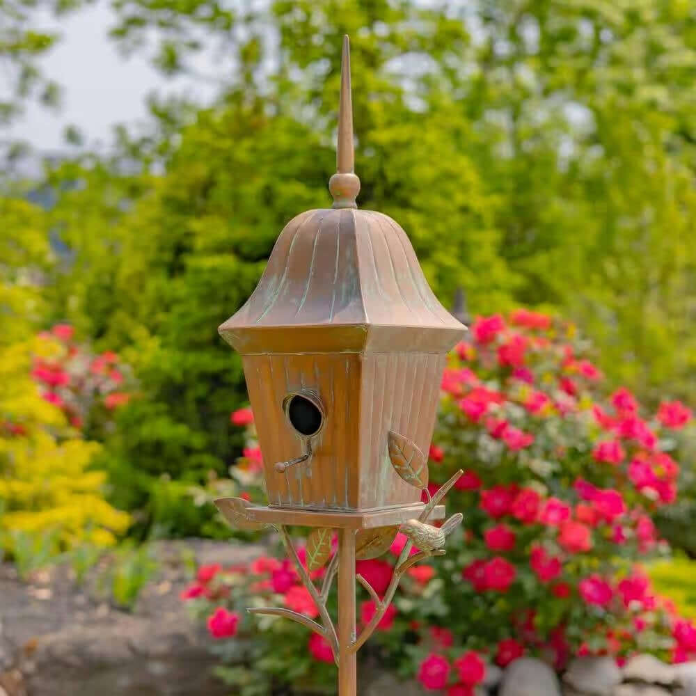 Vintage Copper Finish Garden Birdhouse with Stake in a colorful garden