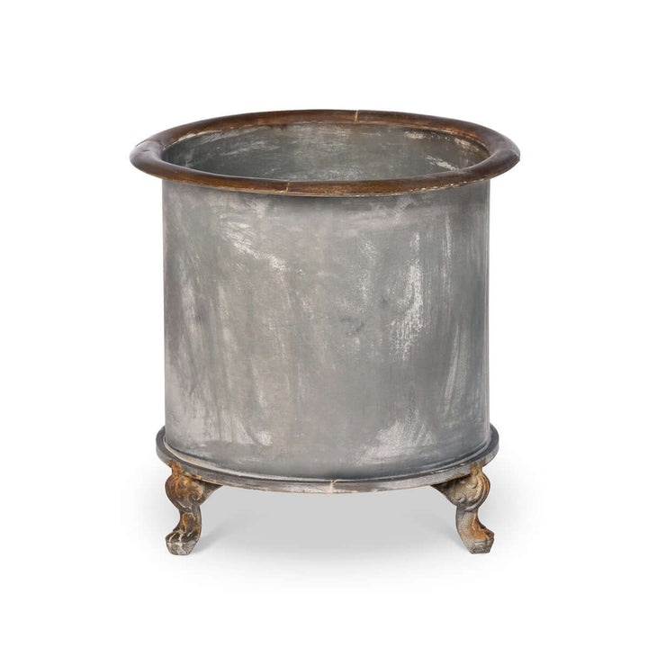 Vintage Creamery Tank Footed Planter made of iron with four scrolled feet, featuring a rustic patina finish, inspired by early 20th-century dairy farms.