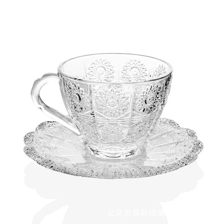 Close detail of the patterned teacup, curved handle, and matching saucer
